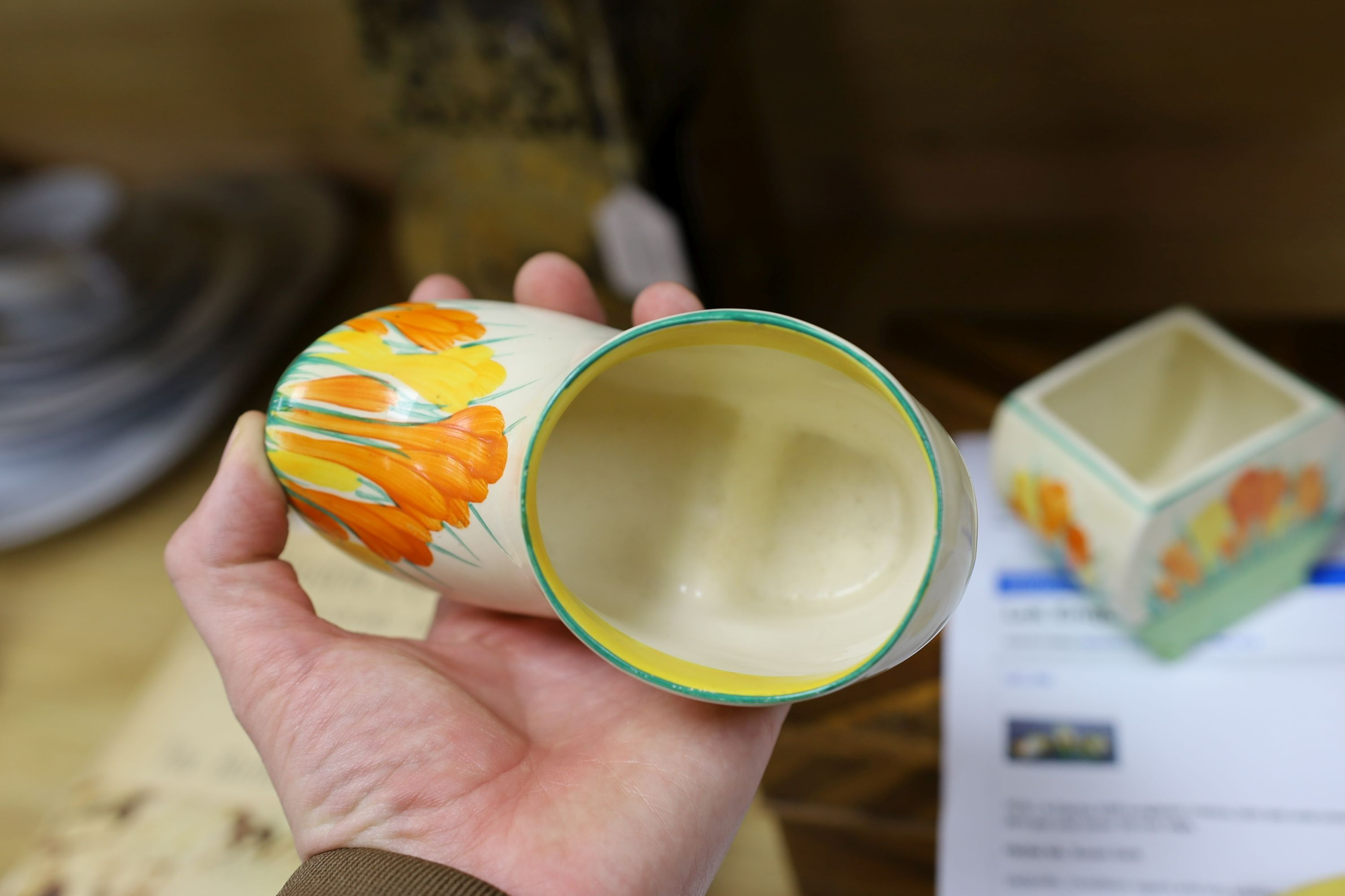 A Clarice Cliff sungleam crocus jam pot and cover, a sugar shaker and a Dutch clog ornament (3), jam pot and cover 10 cms high